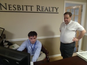 Stuart explains something to his father Will Nesbitt while at the office