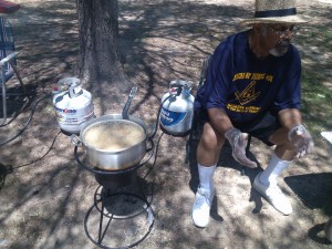 A gentleman fries some food at Pohick Regional Park
