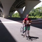 Aubrey Nesbitt takes a break from riding his bicycle below the Woodrow Wilson Bridge