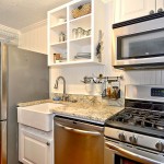 Refrigerator, sink, dishwasher, and stove in this condo